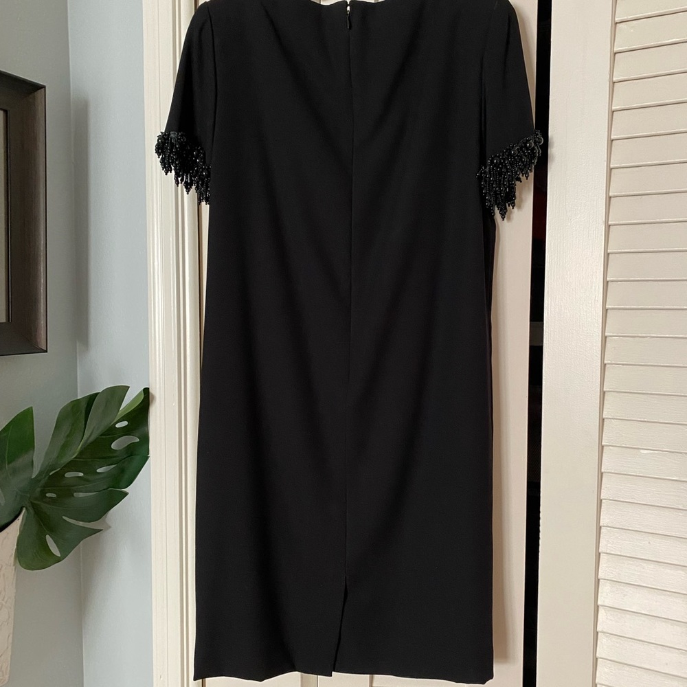 Vintage dressy knee-length black sheath with jet embellishment on short sleeves.
